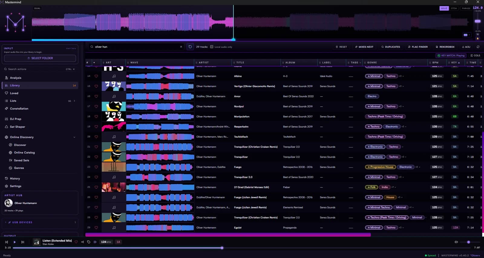The Mastermind desktop library filtered to one artist — every track with its BPM, key, label and genre, a colour waveform on each row, and the artist hub open in the sidebar